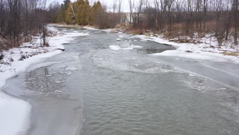 icy winter river stream low flight aerial