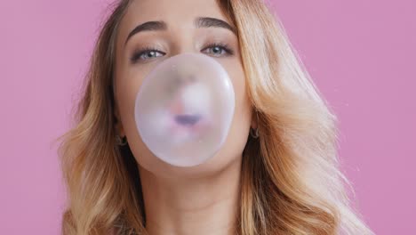 mujer soplando una burbuja de chicle