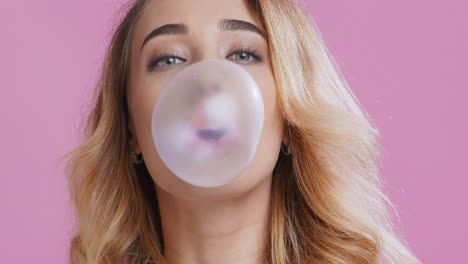 woman blowing a bubblegum bubble