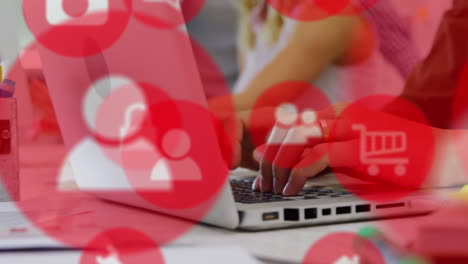 animation of multiple icons over cropped hands of caucasian woman typing on keyboard of laptop