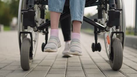 Legs-of-schoolgirl-with-spinal-injury-sitting-in-wheelchair