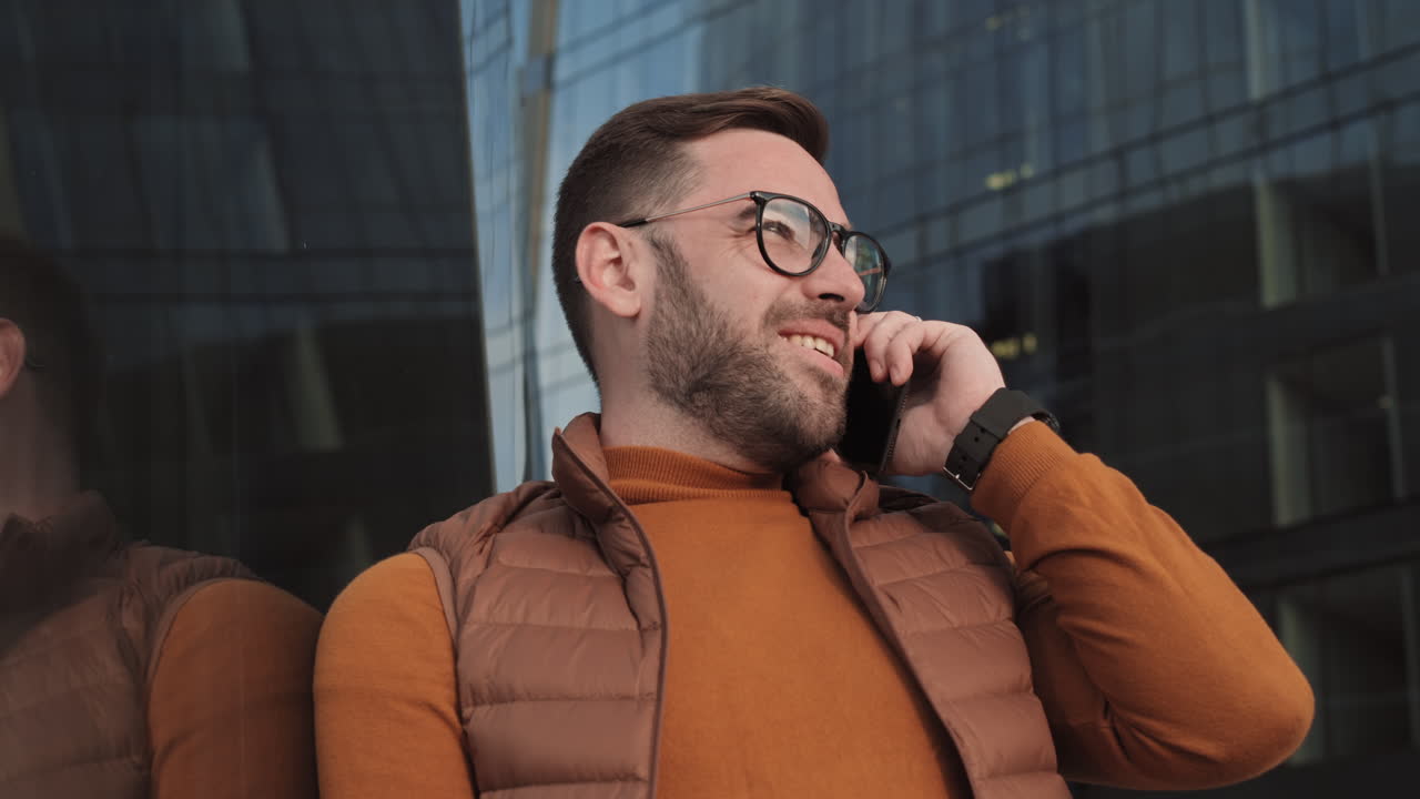 Talking on Phone by Modern Buildings