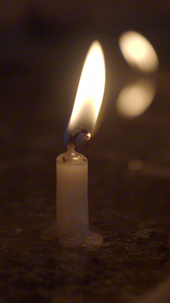 Peaceful Candle Flame Flickering in Darkness