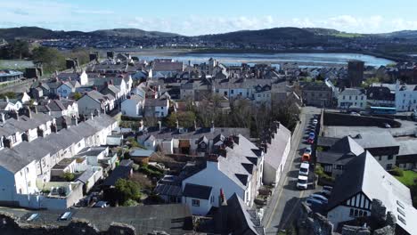 welsh holiday cottages enclosed in conwy castle stone battlements walls aerial view panning right