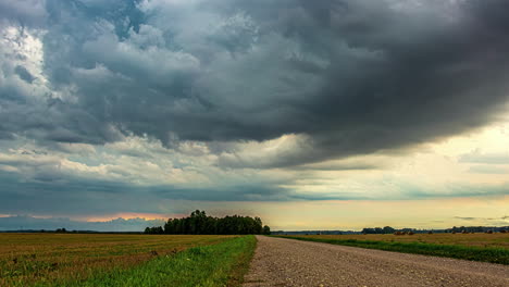 harvest season with working tractor under gloomy cloudy sky