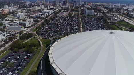 4k aerial drone video of domed roof of tropicana field with waterfront skyline of downtown st