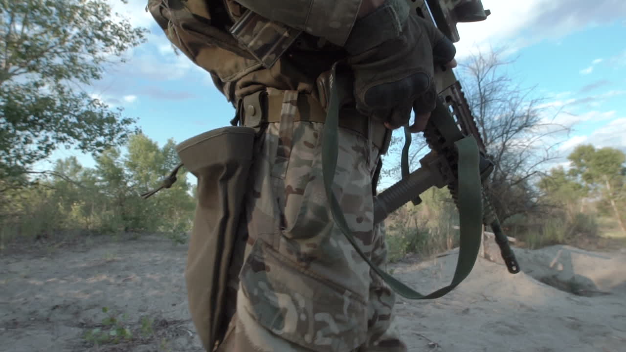Soldier with Sniper Rifle in Camouflage Uniform