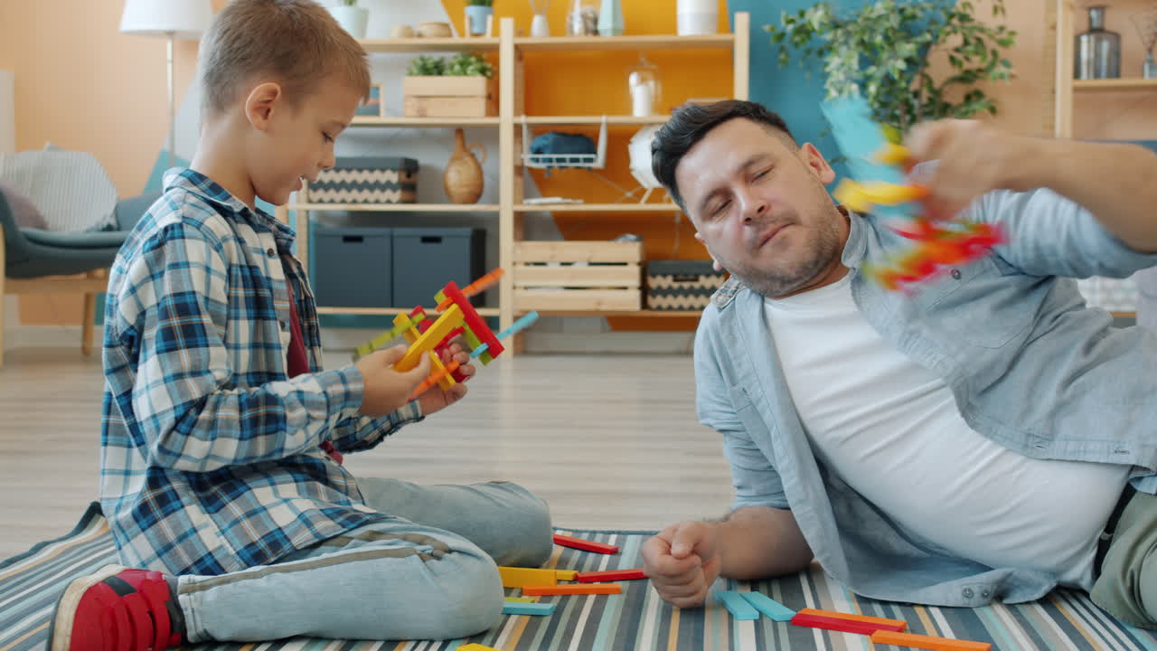 Father and son playing with building blocks