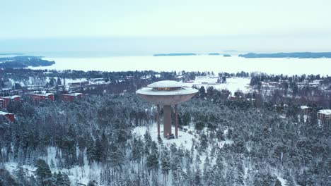 snow-covered park and water tower in espoo, finland.