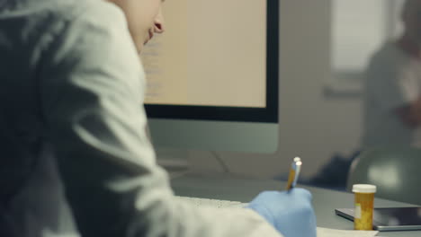 woman therapist making medical journal entries at hospital workplace close up.