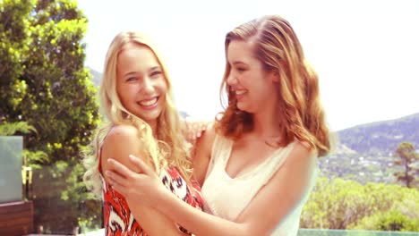 pretty friends embracing and laughing