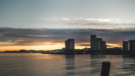 Timelapse-of-a-sunrise-taken-from-a-the-harbour-at-the-city-of-Trondheim,-Norway