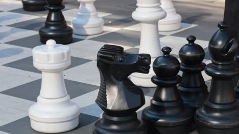 large chess pieces on a checkered board