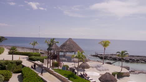 a panning drone shot of a mexican resort setting up for a wedding