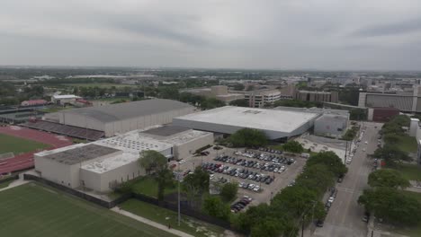 Fertitta-Center-baskeball-on-the-campus-of-the-University-of-Houston-in-Houston,-Texas-with-a-drone-video-moving-in