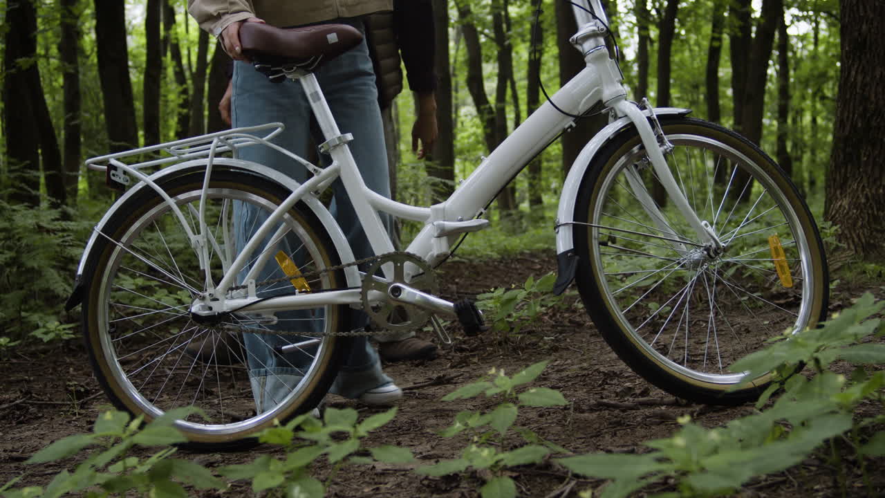 People with a bicycle in the forest