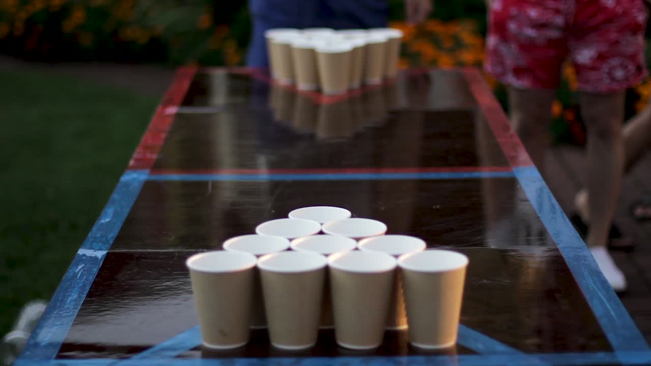 homemade beer pong table with paper cups. The ball gets in the cup
