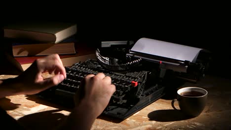 Person Typing on a Typewriter at Night