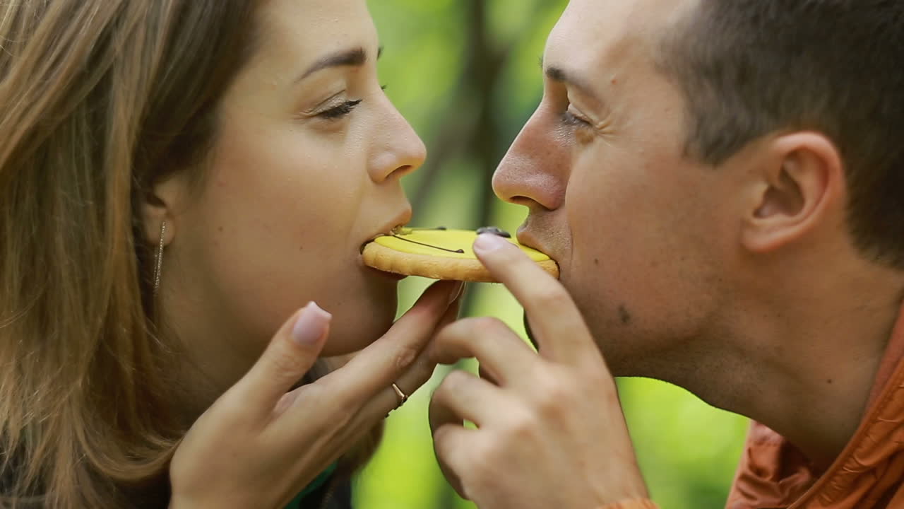 Couple In Nature Drinking Tea. Happy couple drinking black tea together outdoors in nature