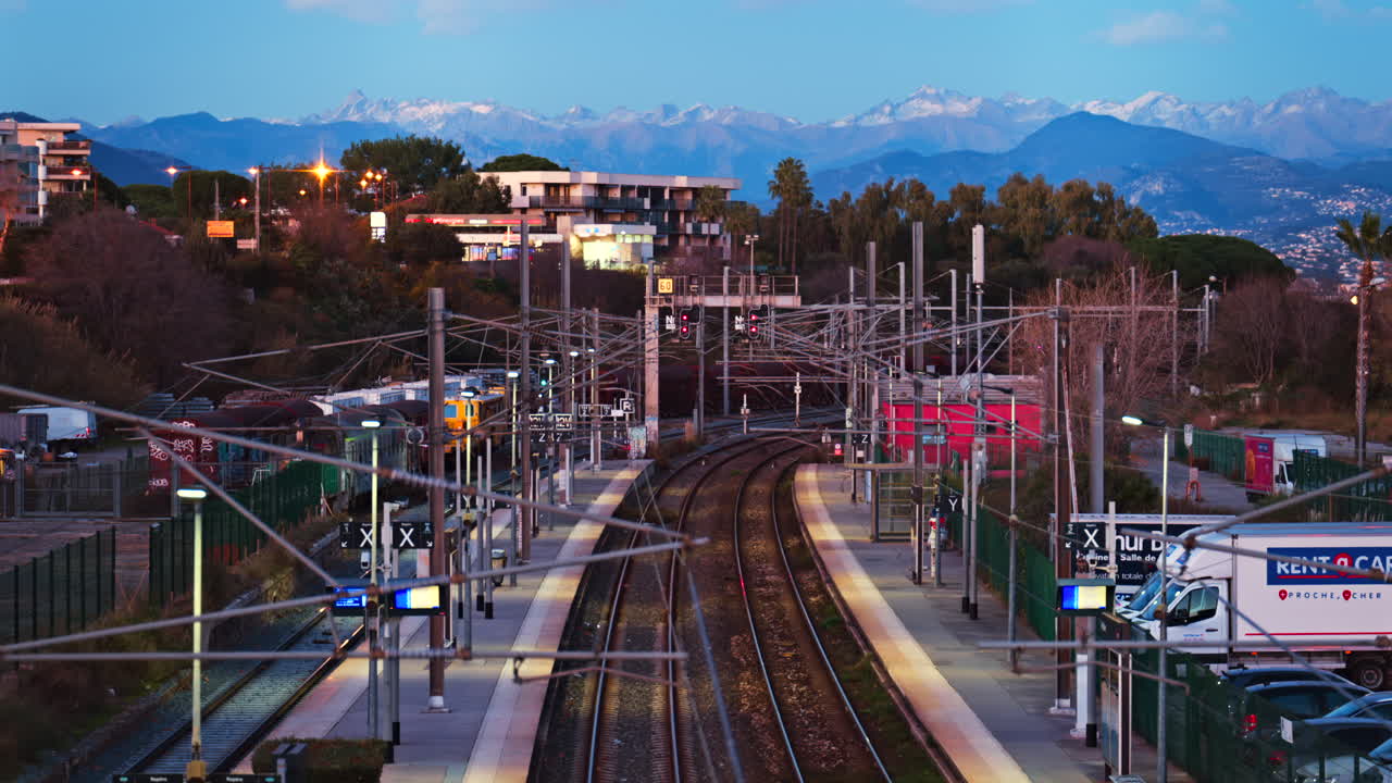 Antibes, France - January 25, 2025: Train station in Antibes with a distant view of the mountains in the evening