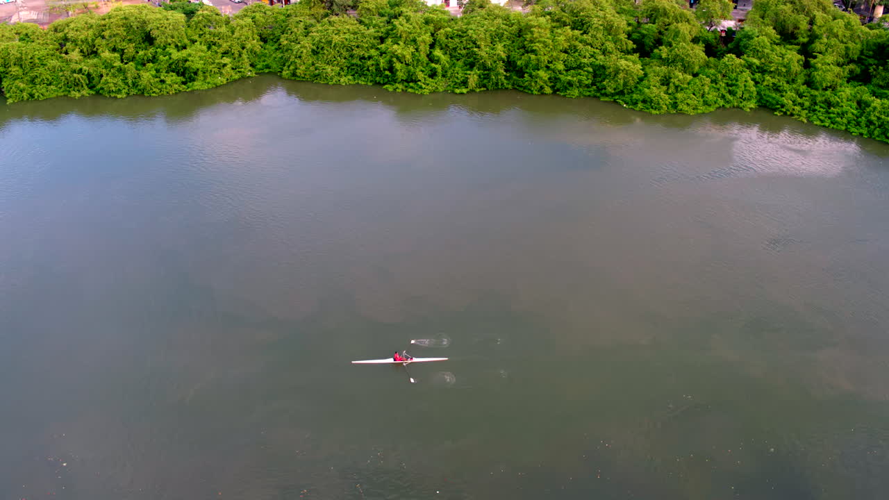 Aerial view of rowing boat activity on the Capibaribe River in Recife Antigo Pernambuco Brazil showcasing nautical sports within the historic city center waterway.