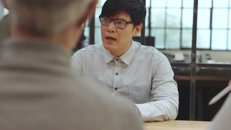 close-up of man face talking during a meeting.