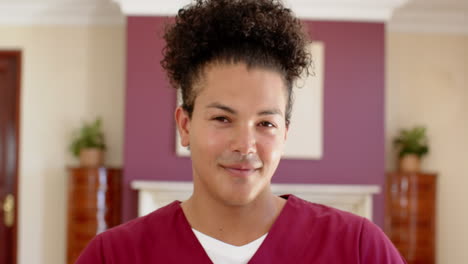 carer in maroon uniform smiling gently at home, feeling content, copy space