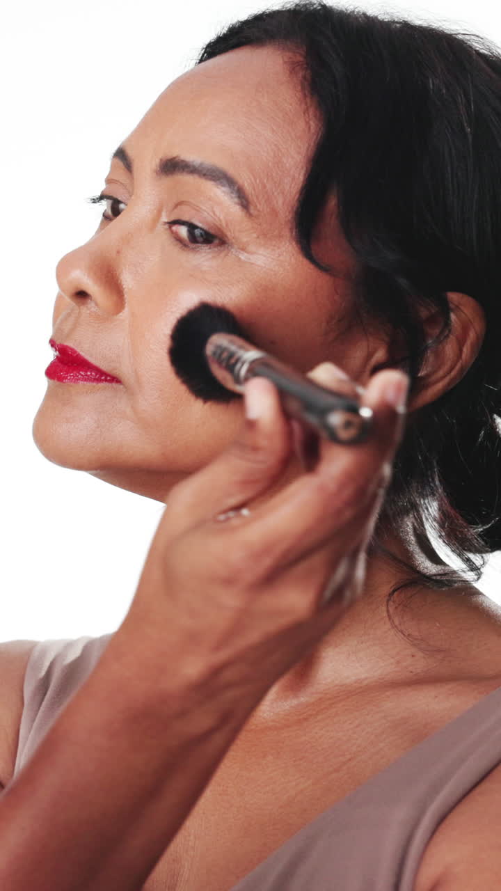 Mature Woman Applying Makeup with a Brush