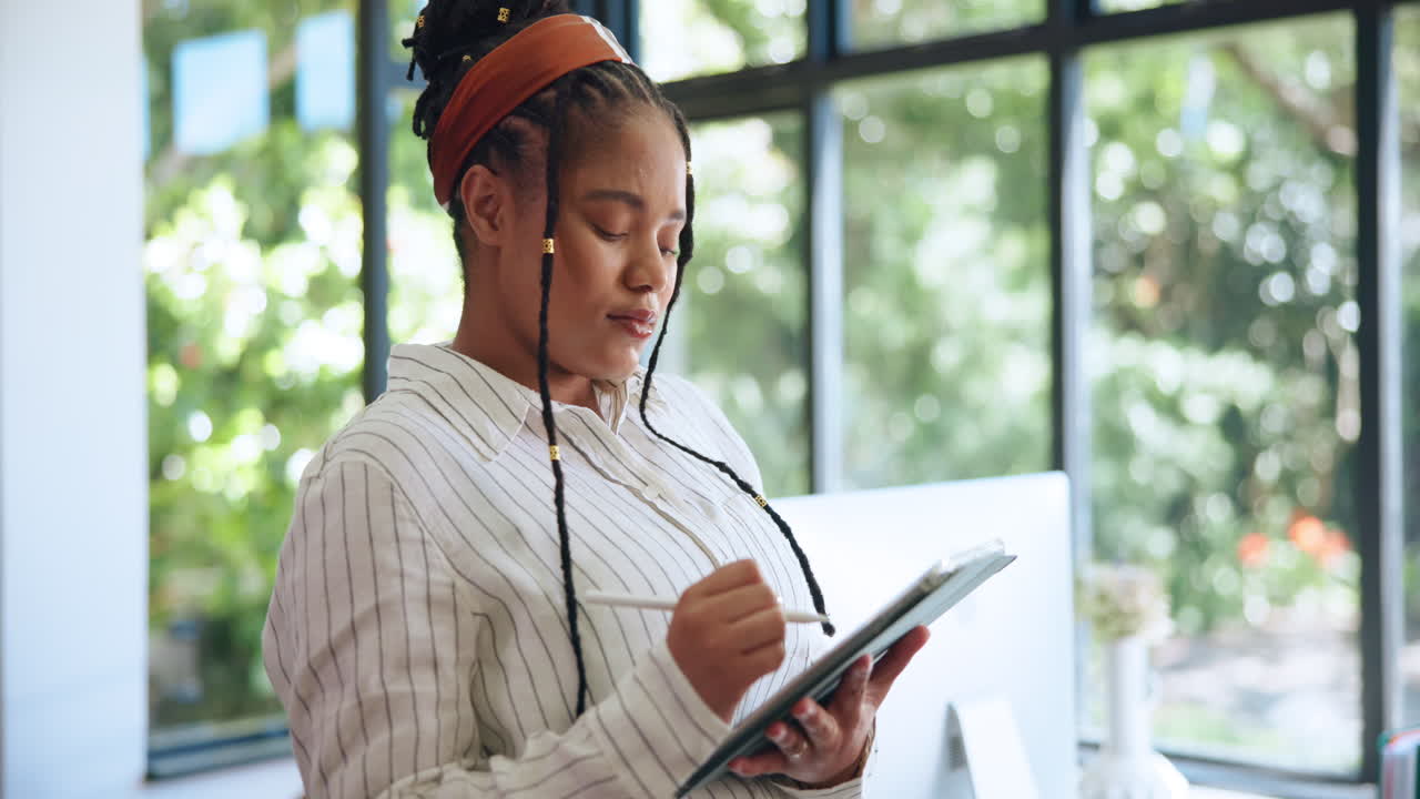 Professional Woman Using Digital Tablet with Stylus in Office