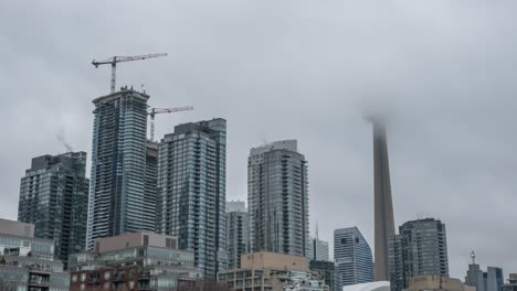 time lapse zoom out shot of beautiful skyline of downtown during a foggy morning in toronto, canada