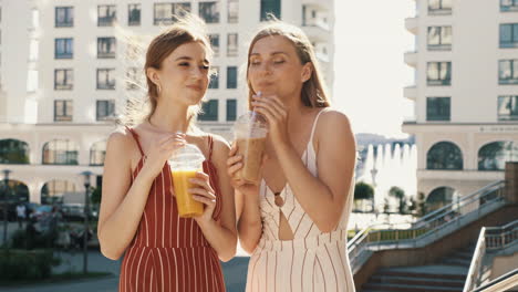 two friends enjoying drinks in the city