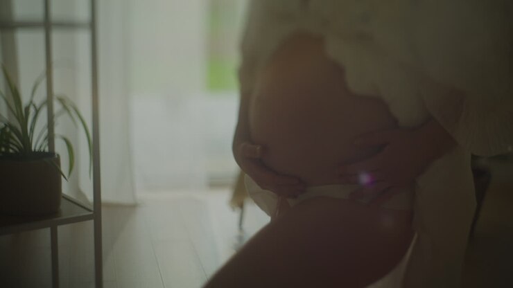 Close-up of Pregnant Woman Gently Touching Belly