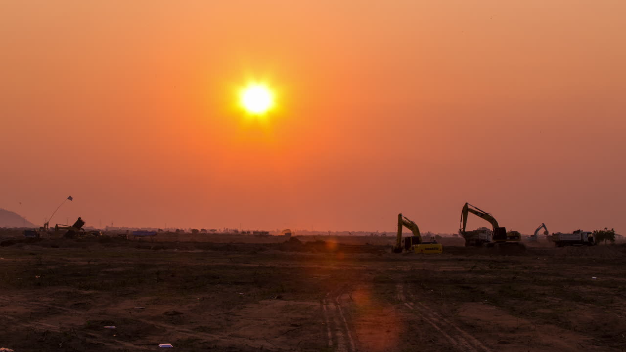 silueta de excavadoras cavando en el sol dorado, espacio de copia
