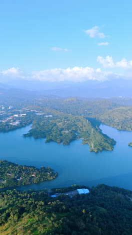 jaw-dropping scenery of the green panorama of sri lanka. sunny view of inhabited area around the beautiful river. top view. vertical video.