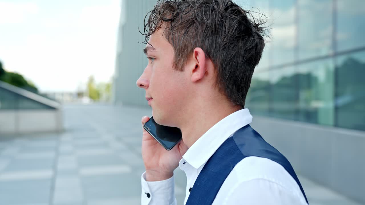 Close Up Of A Young Businessman Talking On His Smartphone