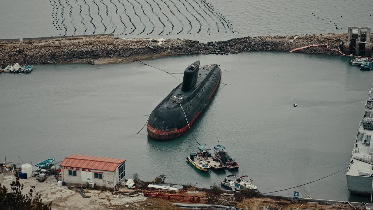 Aerial View of an Old Decommissioned Submarine Docked in a Coastal Harbor