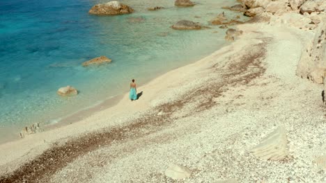 female greece tourist exploring erimitis bay beach in paxos, ionian islands