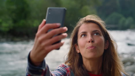 girl having video chat on mobile phone. emotional woman gesturing hand at camera