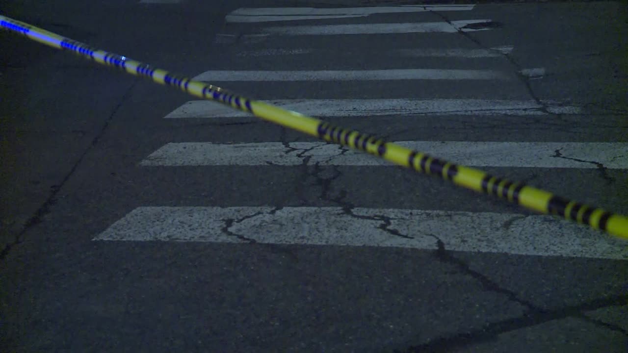 POLICE TAPE OVER CROSSWALK AT NIGHT