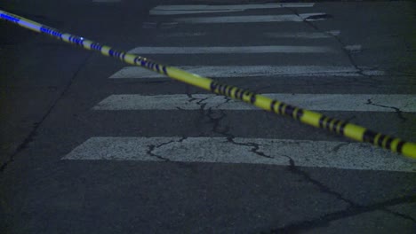 police tape over crosswalk at night