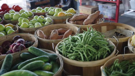 fruits and vegetables in baskets at a farmers market