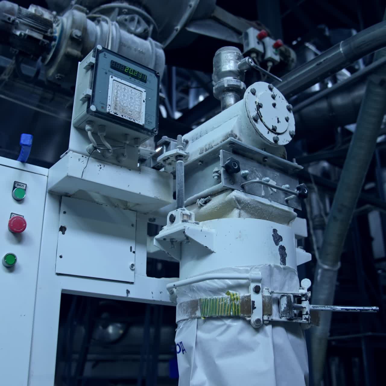 Controller box with buttons and timer as part of the equipment at modern industrial production. Big engine attached to the controller box, ready to pump dairy product. Close view with gradual distancing