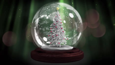 animación de globo de nieve con árbol de navidad sobre brillantes manchas multicolores