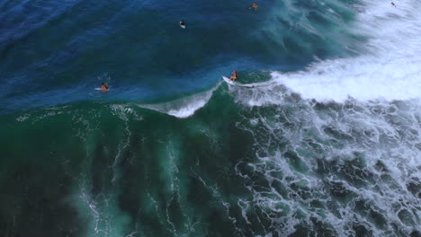 Surfer-rides-a-short-wave-crashing-in-the-ocean-in-Rincon-Puerto-Rico-during-a-clear-day-with-blue-sky