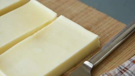 sliced cheese on a cutting board