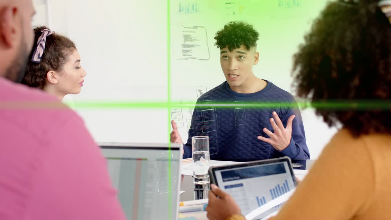 Male speaker opening business meeting, animating green crosshair and syncing team on tablet chart