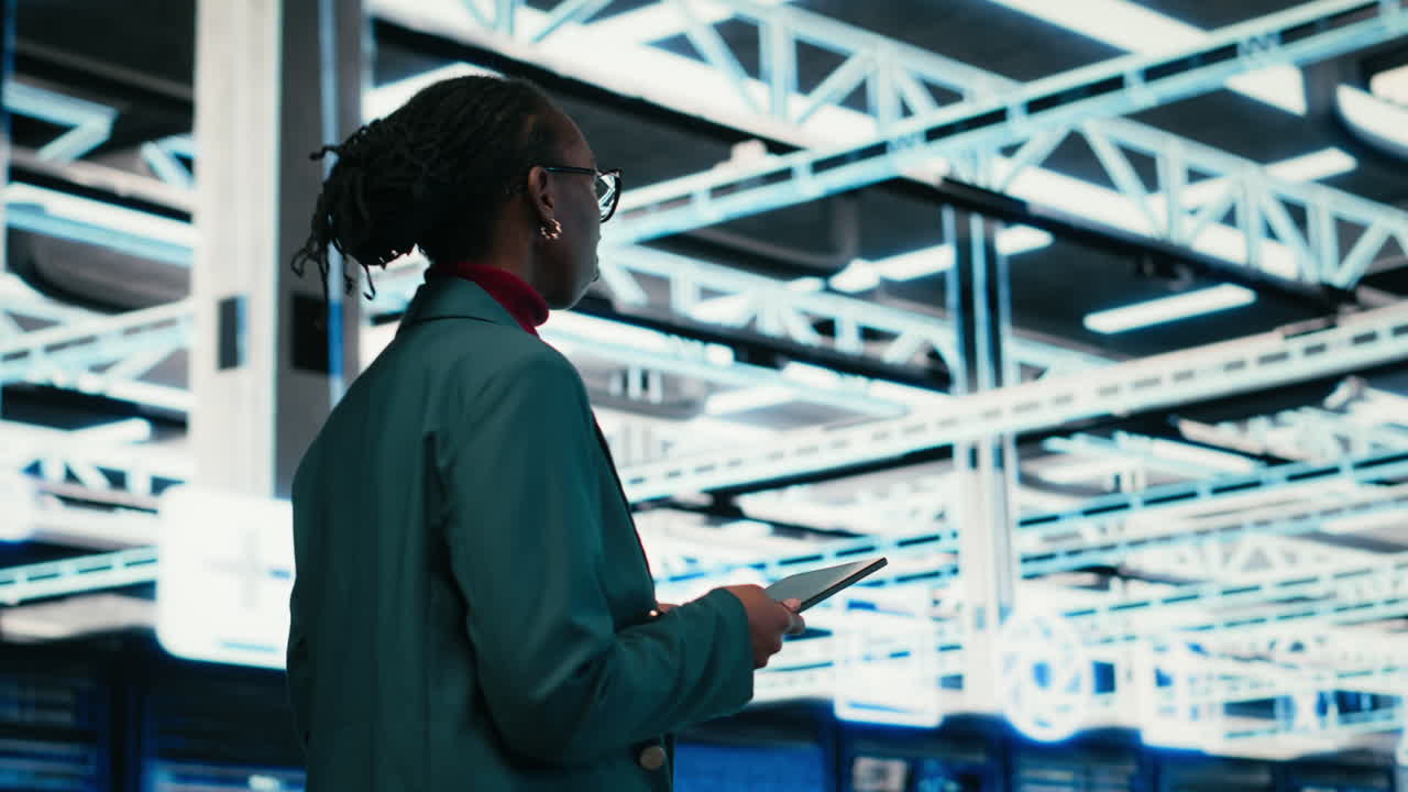 Ingeniera afroamericana usando tablet en centro de datos futurista