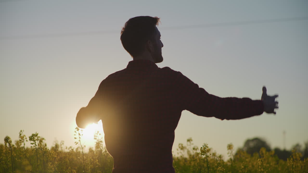 Happy Farmer Sunset Silhouette in Canola Field