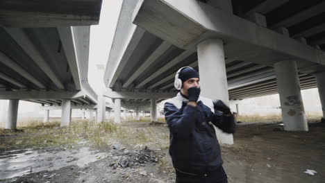 man boxing under an overpass