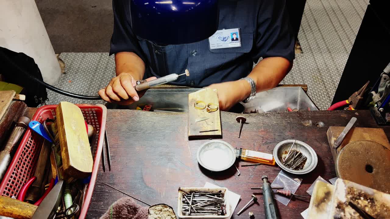 Skilled Goldsmith Crafting Jewelry in a Traditional Workshop